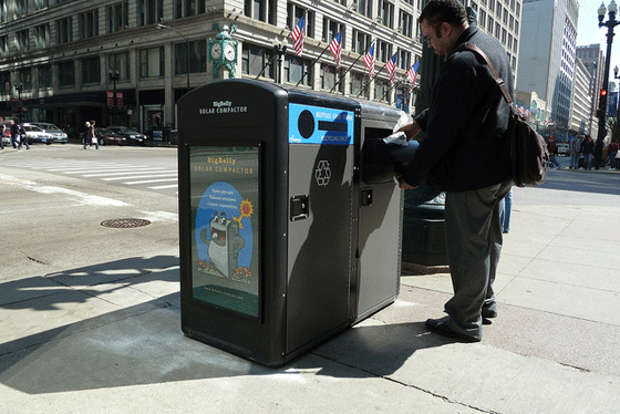 A Chicago citizen enjoys the benefits of a Bigbelly trash compactor.