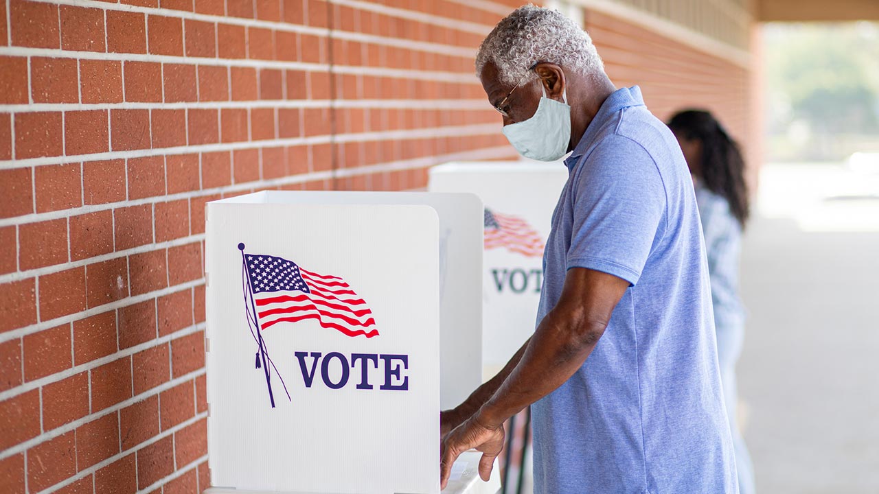 Photo of man casting a vote.