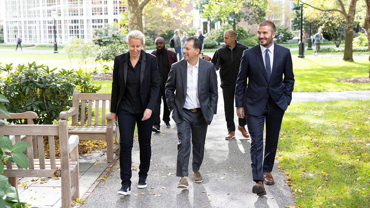 Anita Elberse walks with Authentic Brands CEO Jamie Salter and soccer star David Beckham on the HBS campus. 